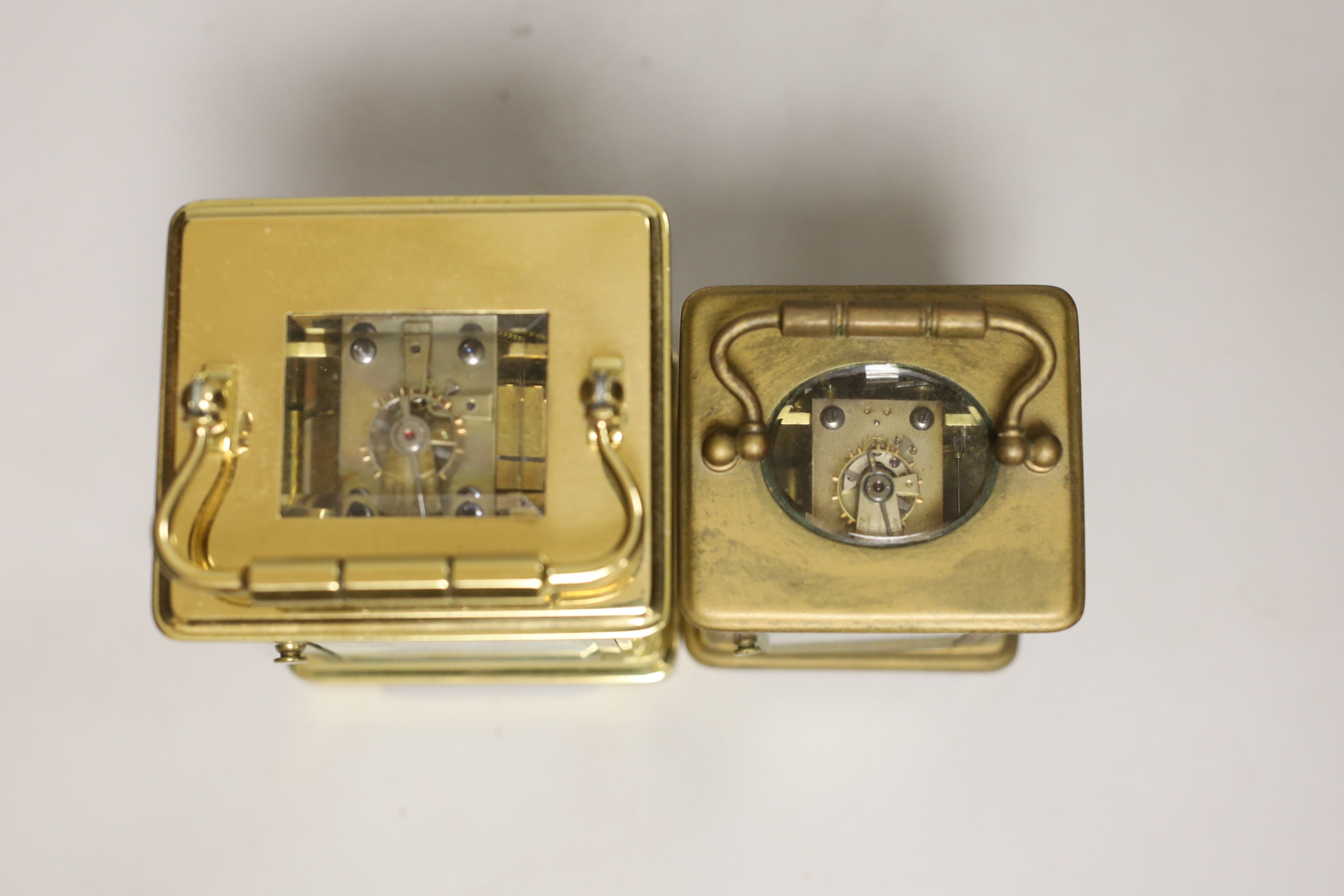 Two cased brass carriage cased clocks, one a repeating carriage clock, tallest 15cm high